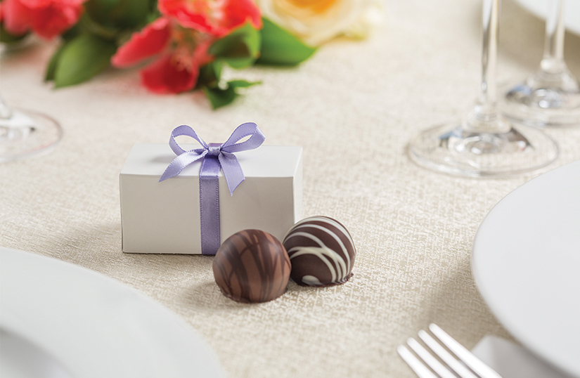 a chocolate fovor shown with a purple ribbon